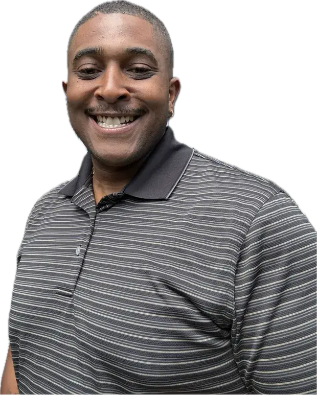 Jeff Ballard Jr. smiling in a striped polo
