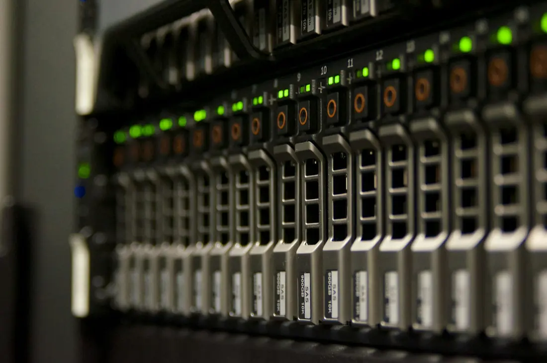 Rows of servers with green status lights in a data center